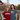 Two girls stand on a bridge. One wears a Harvard shirt and hat. The other wears an MIT shirt.